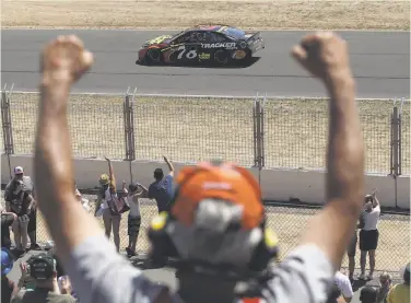  ?? Ezra Shaw / Getty Images ?? Fans celebrate as Martin Truex Jr. does a victory lap after winning the NASCAR race in Sonoma. It was the 18th career Cup win for Truex, his third of the season and the third road-course victory of his career.