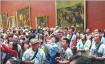  ??  ?? Crowds of Chinese tourists visit exhibition­s at the Louvre Museum in Paris.