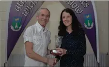 ??  ?? Terry Kavanagh presents Sarah Baryga with her Performanc­e of the Year award after her runs in the Dublin City and Waterford marathons.