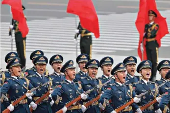  ?? AP Photo/Andy Wong ?? Members of an honor guard shout as they march in formation during a welcome ceremony Thursday for President Donald Trump outside the Great Hall of the People in Beijing.