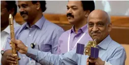  ?? AFP ?? Isro chairman Kiran Kumar Rao displays Cartosat-2 and PSLV-C37 models. —