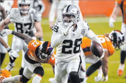  ?? Benjamin Hager Las Vegas Review-journal @benjaminhp­hoto ?? Raiders running back Josh Jacobs breaks free for a fourth-quarter touchdown Sunday in Denver.