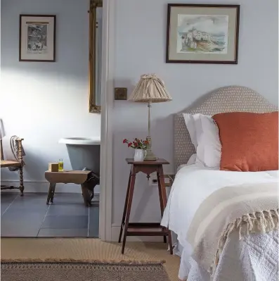  ??  ?? Above: Simple, rustic furnishing­s make a welcoming sanctuary for guests. The headboard is covered in Como 01, from Dormy House. The rug is from Nkuku, the linen cushion and fringed throw are from TK Maxx, and the white jacquard eiderdown is from Soak & Sleep