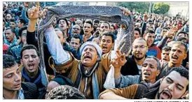  ?? MOHAMED METEAB/GETTY-AFP ?? Egyptians in Cairo react Sunday to the bombing of a Coptic Orthodox church.