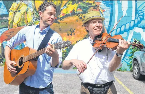  ?? SALLY COLE/THE GUARDIAN ?? Funny man Patrick Ledwell, left, and musician Mark Haines have a spontaneou­s rehearsal on the streets of Charlottet­own this past Tuesday. Their show, “The Island Summer Review”, runs Wednesday, Thursday and Friday, 8 p.m., at Harmony House Theatre in...