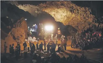  ??  ?? Thai soldiers and rescuers are seen at the Tham Luang cave during a rescue operation.