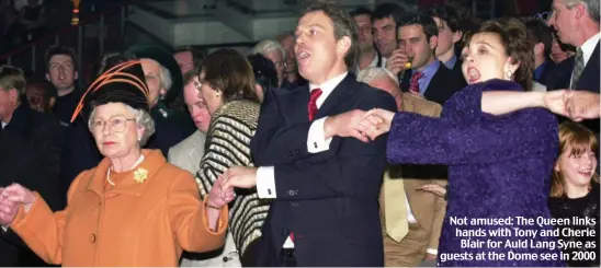  ?? ?? Not amused: The Queen links hands with Tony and Cherie Blair for Auld Lang Syne as guests at the Dome see in 2000