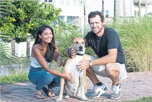  ?? CHARLOTTE KESL THE NEW YORK TIMES ?? Maya Brown and Lanto Griffin have travelled around the eastern United States with their new dog, Troy, this summer.