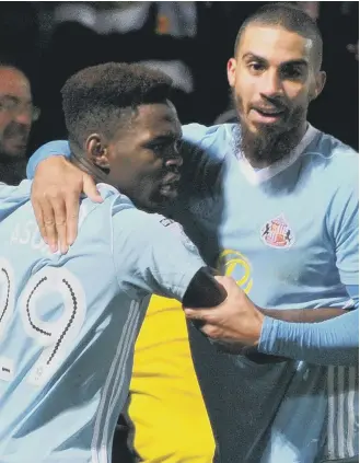  ??  ?? Joel Asoro celebrates his part in Sunderland’s second goal at Burton with striker Lewis Grabban.