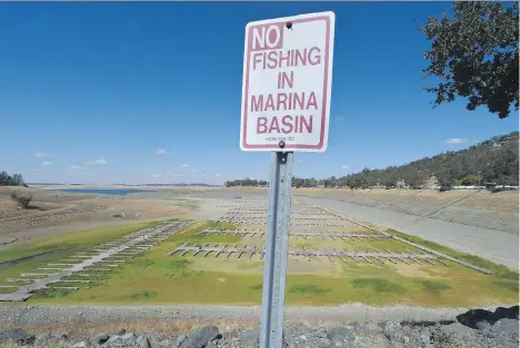  ?? MARK RALSTON/AFP/GETTY IMAGES/FILES ?? A sign of the times: Boat docks sit empty on dry land last year on Folsom Lake reservoir near Sacramento, Calif. Far away in the distance you can see water. The Golden State is experienci­ng a severe drought that has entered its sixth year.