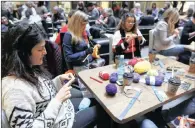  ??  ?? South African women knit blankets for the homeless at Mandela Rhodes Place in Cape Town.