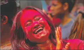  ?? (AP/Anupam Nath) ?? An Indian woman dances during Holi festival celebratio­ns in Gauhati, India.