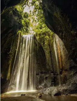  ??  ?? ABOVE The Tukad Cepung waterfall near Ubud is in a secluded cave down a steep flight of mossy stairs. If you get there fairly early, you’ll catch the light shining into the cave at a perfect angle.