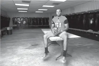  ?? Casey Jackson/Corpus Christi Caller-Times via AP ?? ■ Refugio defensive lineman Armonie Brown sits in the high school’s locker room in Refugio, Texas, this month. Brown saw friends and teammates lose their homes and all their belongings, while the school he went to was heavily damaged by Hurricane Harvey that hit Aug. 25, 2017.