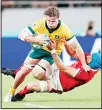  ??  ?? Australia’s Michael Hooper (left), is tackled by Wales’ Justin Tipuric during the Rugby World Cup Pool D game at Tokyo Stadium between Australia and Wales in Tokyo,
Japan on Sept 29, 2019. (AP)