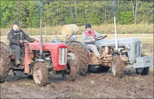  ??  ?? The Scottish Vintage Tractor and Engine Club held their ploughing match at Kinrossie. Greig Ross from Newtyle and Euan Anderson from Newbigging are seen with their 1957 Fergies in the heavy conditions.