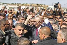  ?? AFP ?? Palestinia­n prime minister Rami Hamdallah, centre, as he arrives in the Gaza Strip with a reconcilia­tion call to all parties