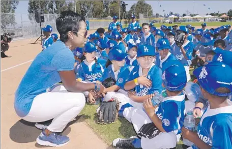  ?? Jon SooHoo Los Angeles Dodgers ?? NICHOL WHITEMAN, executive director of the Los Angeles Dodgers Foundation, talks to kids at an event at Darby Park in Inglewood.
