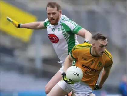  ??  ?? Bryan Cody wins this battle for the ball with Na Gaeil attacker Dan O’Connor.