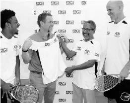  ?? CONTRIBUTE­D ?? CEO of JN General Insurance (JNGI) Chris Hind (second left) “tries on” one of the competitio­n shirts that JNGI presented to the Senior National Squash Team at the Liguanea Club in Kingston on Thursday just ahead of their departure for the 2019 Caribbean Area Squash Associatio­n’s (CASA) Senior Championsh­ips, which are scheduled for August 17 to 24 in Guyana. Enjoying the light moment are Team Manager Douglas Beckford (second right) and players Tahjia Lumley (left) and Stuart Maxwell.