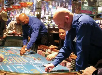  ?? THE ASSOCIATED PRESS ?? This April 20 photo shows a game of craps underway at Resorts Casino Hotel in Atlantic City, N.J. As Atlantic City’s casinos mark their 40th anniversar­y, the industry is hailing the reopening of two of the five casinos that shut down since 2014, though...