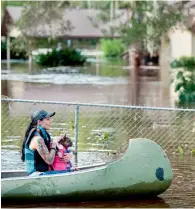  ?? — AFP ?? A woman and her dog navigate floodwater­s caused by Hurricane Irma in Middleburg, Florida.