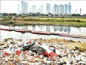  ?? AFP ?? Plastic waste lies along a river bank in Jakarta. Global concern over plastic pollution has been spurred by shocking images of waste-clogged rivers in Southeast Asia and accounts of dead sea creatures found with kilos of refuse in their stomachs.