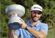  ?? ERIC GAY — THE ASSOCIATED PRESS ?? Dustin Johnson holds his trophy after defeating Jon Rahm at the Dell Technologi­es Match Play tournament Sunday in Austin, Texas.