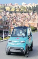  ?? AP ?? Dr. Carlos Ortuño drives a Bolivianma­de, Quantum electric car to a house call in La Paz.