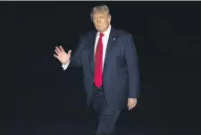  ?? ANDREW HARNIK - THE ASSOCIATED PRESS ?? President Donald Trump waves to members of the media while walking across the South Lawn of the White House in Washington, Friday, July 10, as he returns from a trip to Florida. President Donald Trump commuted the sentence of his longtime political confidant Roger Stone on Friday, just days before he was set to report to prison.