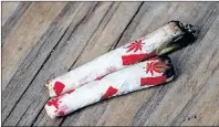  ?? CP PHOTO ?? Marijuana joints rolled with Canadian-themed paper are photograph­ed at a “Wake and Bake” legalized marijuana event in Toronto last week.