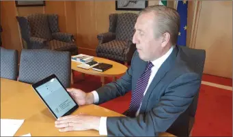  ?? Minister Michael Creed having a look at the new app. ??