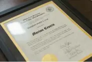  ?? ?? A certificat­e presented to recipient Marion Cronin on Dec. 29 is displayed at her nursing home in Rye, Maine.