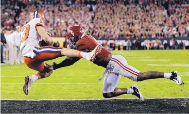  ?? DAVID J. PHILLIP/ASSOCIATED PRESS ?? Clemson’s Hunter Renfrow catches a touchdown pass in front of Alabama’s Tony Brown during Monday night’s national championsh­ip. Clemson beat Alabama 35-31 to earn its first national title since 1981.