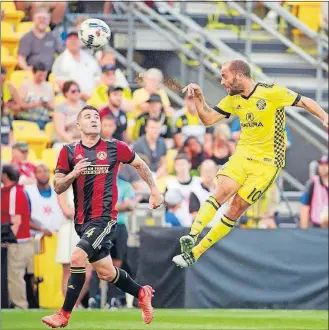  ?? PERENIC/DISPATCH] [BARBARA J. ?? Federico Higuain of the Crew gets the ball past Greg Garza of Atlanta United.