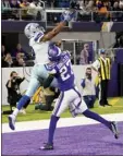  ?? AP photo ?? Amari Cooper of the Cowboys catches a 5-yard touchdown pass over Vikings cornerback Cameron Dantzler in the final minute of Sunday’s game.