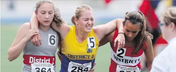  ?? PHOTOS: JASON KRYK ?? Lexi Kundlacz, centre, is assisted by Shelby Deacon, left, and Mariya Suchoplas, right, at the 2017 Royal Canadian Legion Ontario Youth Track and Field Championsh­ips held at the University of Windsor on Sunday. The three girls competed in the youth...