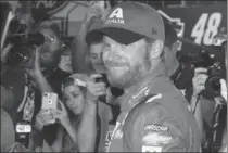  ?? ASSOCIATED PRESS FILE PHOTO ?? Dale Earnhardt Jr. is surrounded while getting out of his car after his last NASCAR race, at Homestead-Miami Speedway on Nov. 19.