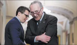  ?? J. Scott Applewhite ?? The Associated Press Senate Minority Leader Chuck Schumer, D-N.Y., right, said he will introduce a bill taking marijuana off the federal list of controlled substances.