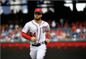  ?? KATHERINE FREY — THE WASHINGTON POST VIA AP ?? Washington Nationals outfielder Bryce Harper warms up prior to Tuesday night’s game against the New York Mets. Despite talk that Harper was on the trading block before Tuesday’s deadline, he is staying put in Washington.