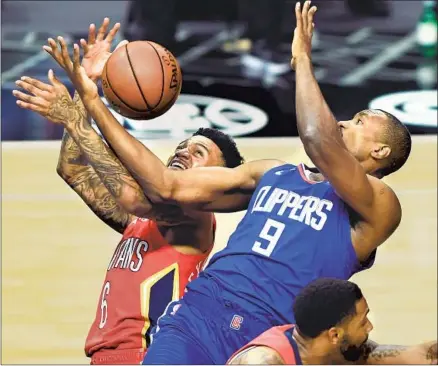  ?? Wally Skalij Los Angeles Times ?? THE CLIPPERS’ Serge Ibaka (9) battles the Pelicans’ Nickeil Alexander-Walker for a rebound during the first quarter.