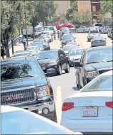  ?? STAFF FILE PHOTO ?? Left: Main Street in downtown Los Gatos turns into a parking lot as beach traffic mixes with local traffic creating a mess for merchants and locals in 2014.