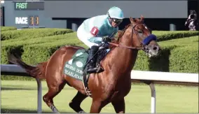  ?? RICHARD RASMUSSEN - THE ASSOCIATED PRESS ?? Martin Garcia, top, and eventual winner Charlatan (1) lead the field past the grandstand during the first division of the Arkansas Derby, Saturday, May 2, 2020, at Oaklawn Racing Casino Resort in Hot Springs, Ark.