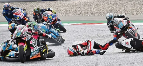  ?? — AFP ?? Mayhem on track: Idemitsu Honda Team Asia’s Somkiat Chantra falls of his bike in the middle of the track after crashing as (from left) Kalex’s Sam Lowes, MB Conveyors Speed Up’s Jorge Navaro all come hurtling during the Moto2 race of the Styrian Grand Prix.