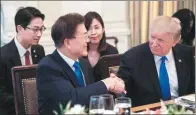  ?? NICHOLAS KAMM / AGENCE FRANCE-PRESSE ?? Donald Trump and Moon Jae-in shake hands before dinner at the White House in Washington on Thursday.