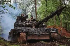  ?? Efrem Lukatsky/Associated Press ?? Ukrainian soldiers drive a tank along the road on Tuesday near Bakhmut in Ukraine’s Donetsk region.