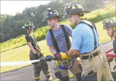  ?? Olivia Drake photos ?? Haddam Volunteer Fire Company responded to 54 calls for emergency services in July. During a weekly drill night July 16, members practiced water pumping and hand-line operations at Eagle’s Landing State Park.
