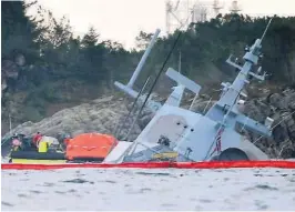  ?? FOTO: NTB SCANPIX ?? SUNKET: En båt med bergingsma­nnskaper ved den havarerte fregatten Helge Ingstad.