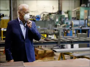  ?? AP Photo/Mat Slocum ?? In this July 9 file photo Democratic presidenti­al candidate, former Vice President Joe Biden adjusts his mask during a tour of McGregor Industries, a metal fabricatin­g facility in Dunmore, Pa.