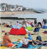  ??  ?? BALMY ARMY On beach in Lyme Regis, Dorset